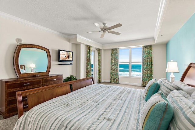 bedroom with ceiling fan, a textured ceiling, light carpet, and a water view