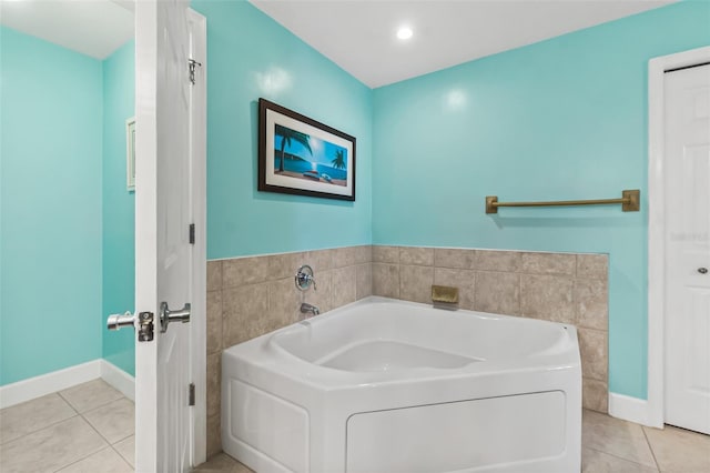 bathroom with tile patterned flooring and a tub