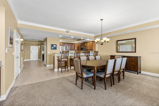 dining space featuring a notable chandelier, a raised ceiling, crown molding, a textured ceiling, and light tile patterned floors