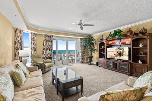 living room with a textured ceiling, ceiling fan, carpet, and ornamental molding