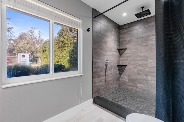 bathroom featuring toilet, tile patterned floors, and walk in shower