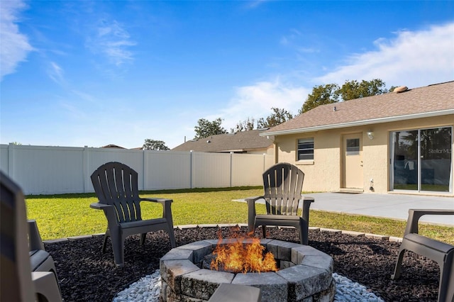 view of yard featuring a patio and an outdoor fire pit