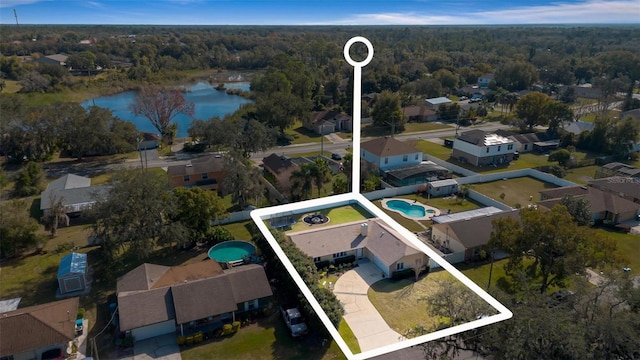 birds eye view of property with a water view