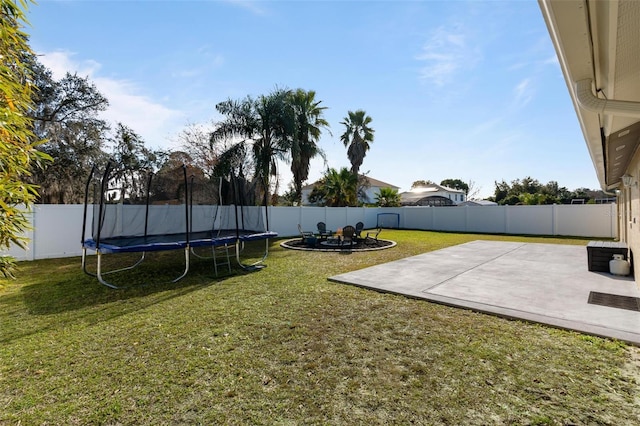 view of yard featuring a patio and a trampoline