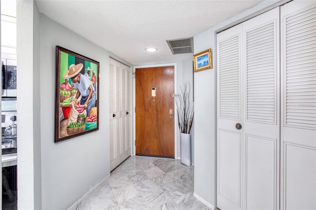 hallway featuring a textured ceiling