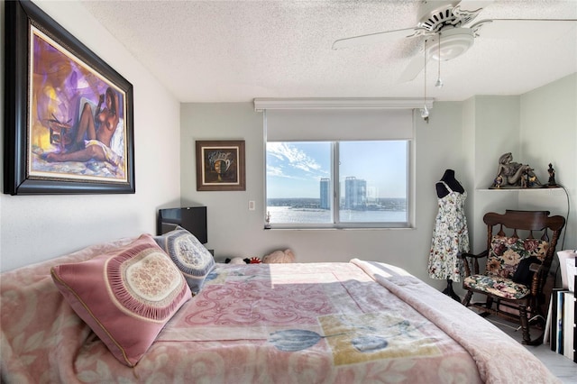 bedroom featuring a textured ceiling and ceiling fan