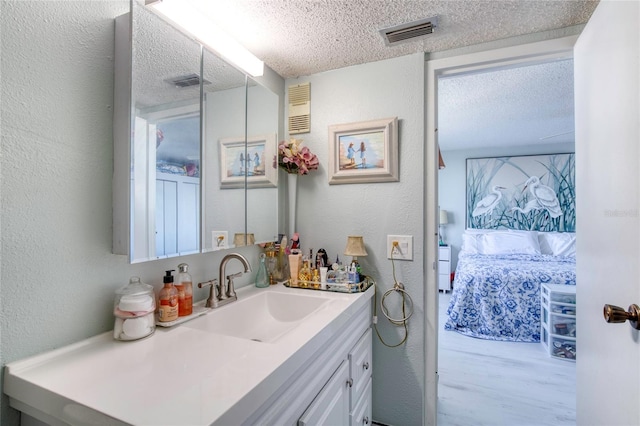 bathroom featuring vanity and a textured ceiling