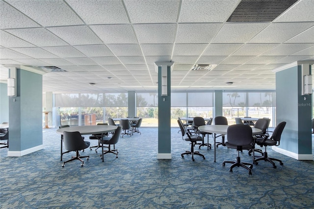 interior space featuring expansive windows and a paneled ceiling