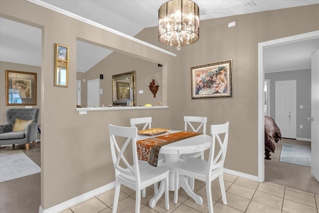 tiled dining space with a notable chandelier and vaulted ceiling