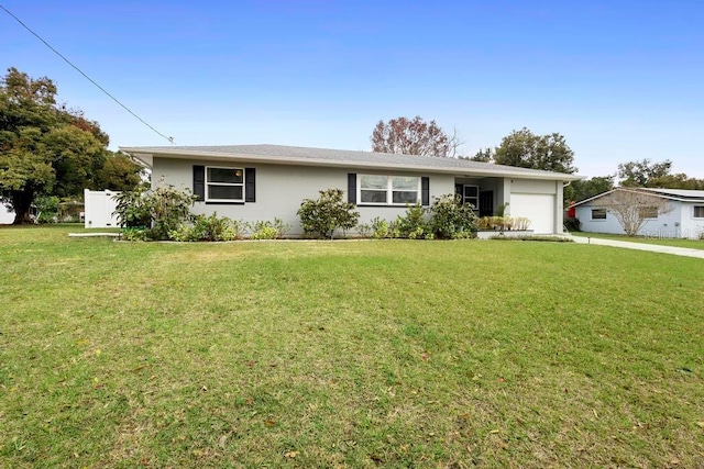 ranch-style house featuring a garage and a front yard