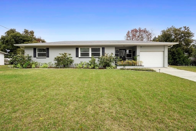 single story home with a garage and a front lawn