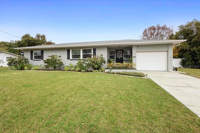 ranch-style home featuring a garage and a front lawn