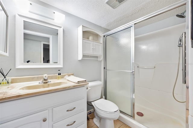 bathroom featuring vanity, a shower with shower door, a textured ceiling, and toilet