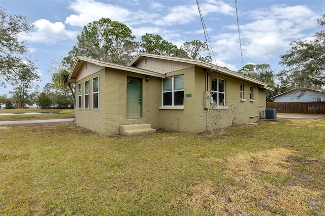 exterior space with a yard and central air condition unit