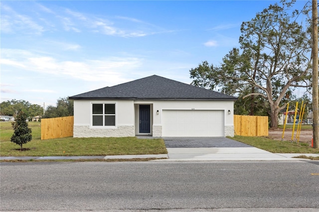 ranch-style house with a garage and a front lawn