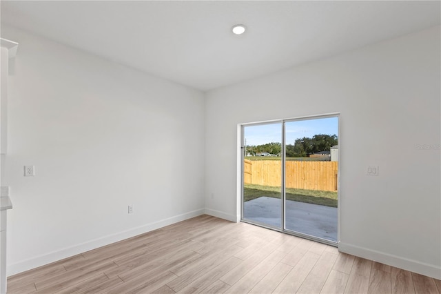 spare room with light hardwood / wood-style flooring