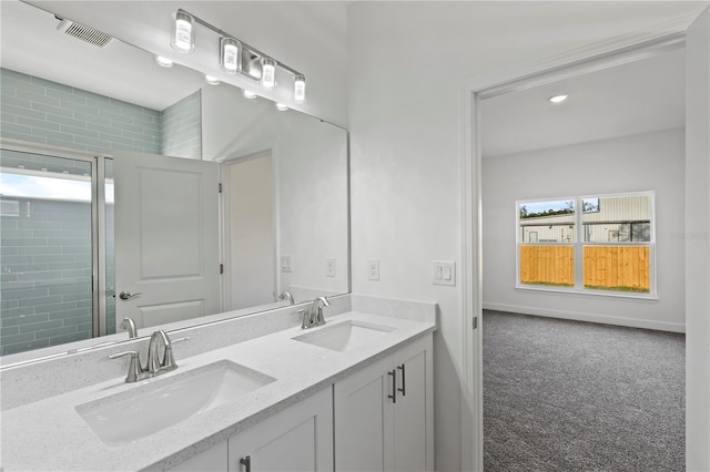 bathroom featuring vanity and a shower with shower door