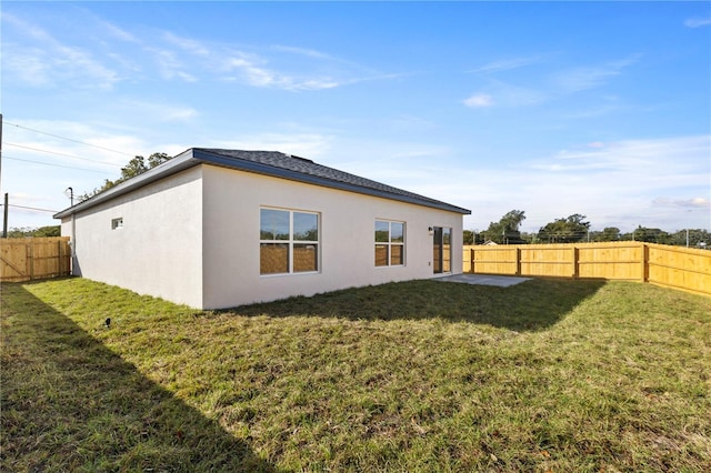 back of house with a lawn