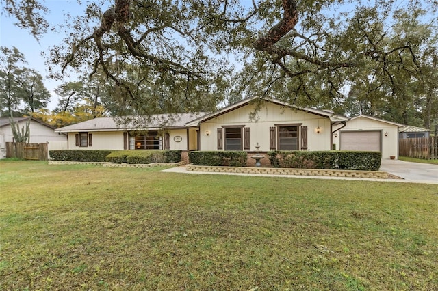 ranch-style home featuring a garage, concrete driveway, fence, and a front lawn