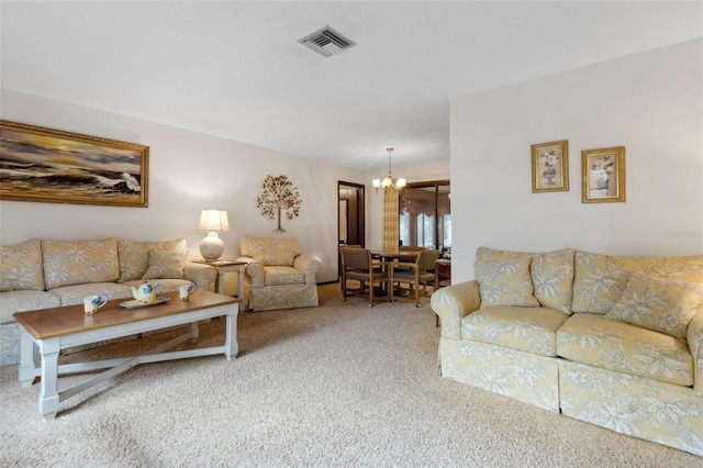 carpeted living room with an inviting chandelier