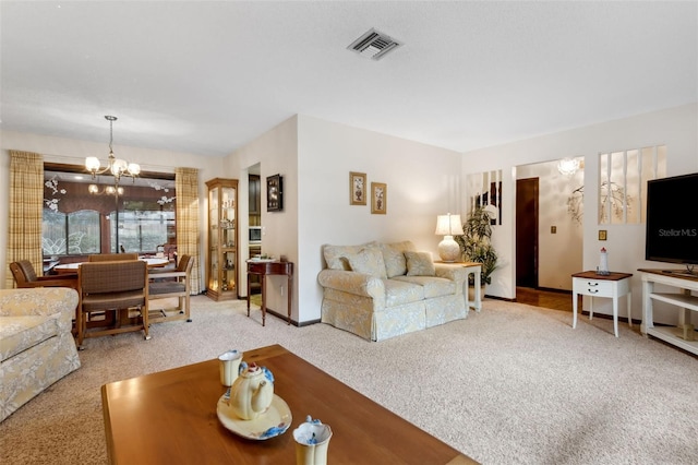 carpeted living room with an inviting chandelier