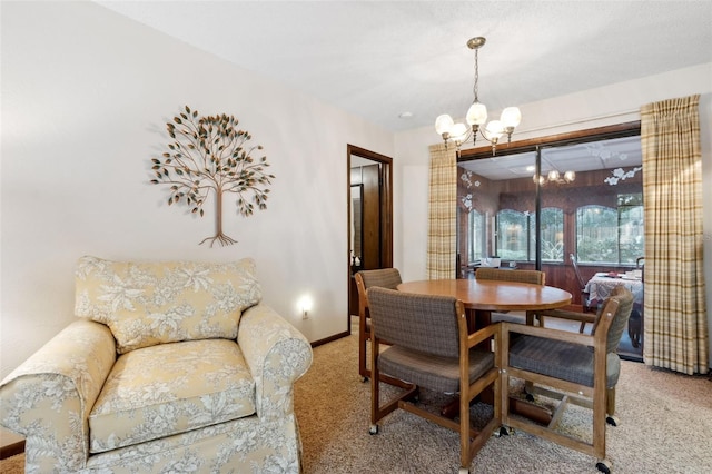 dining space featuring carpet floors and an inviting chandelier