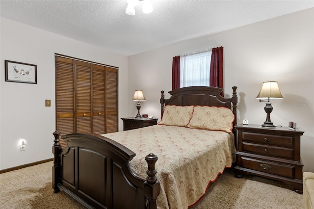 carpeted bedroom featuring a textured ceiling and a closet