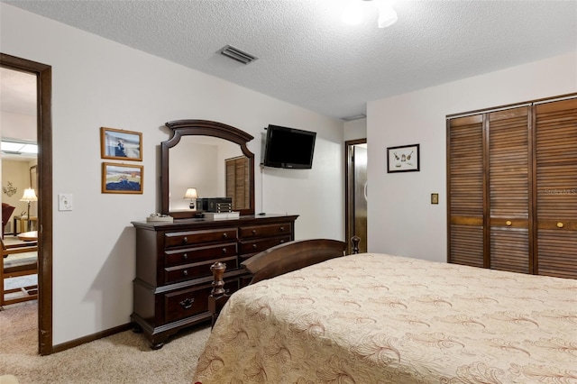 carpeted bedroom featuring a textured ceiling and a closet