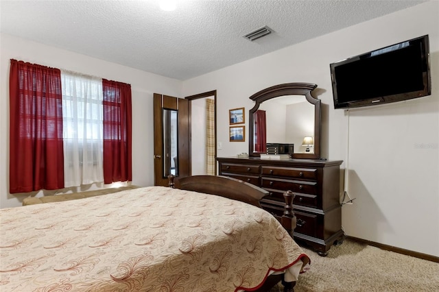 carpeted bedroom featuring a textured ceiling