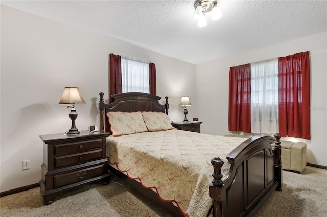 bedroom featuring carpet and a textured ceiling