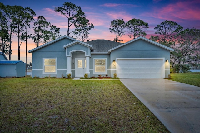 view of front of house featuring a yard and a garage