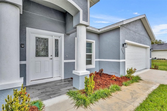 view of exterior entry featuring a garage