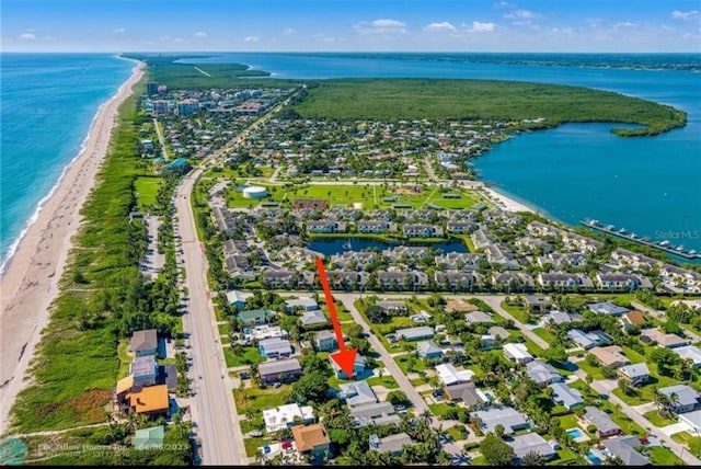 bird's eye view with a water view and a view of the beach