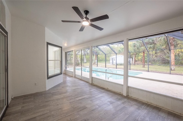 unfurnished sunroom featuring lofted ceiling and a ceiling fan