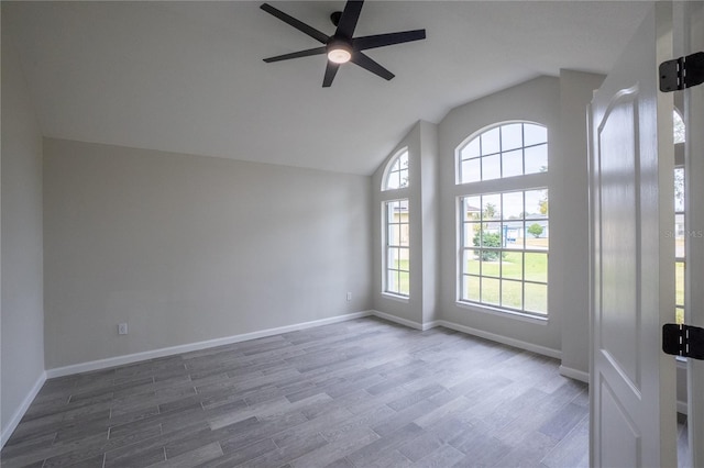 unfurnished room featuring high vaulted ceiling, ceiling fan, baseboards, and wood finished floors