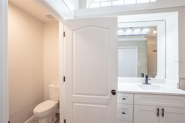 full bathroom with vanity, toilet, and baseboards