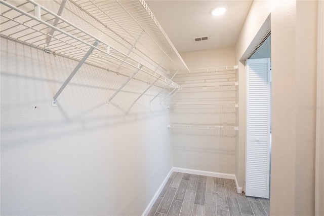 walk in closet featuring visible vents and wood finished floors