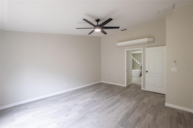 unfurnished room featuring a ceiling fan, light wood-type flooring, visible vents, and baseboards