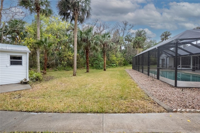 view of yard featuring a lanai and an outdoor pool