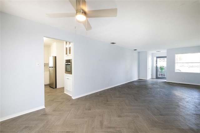 spare room featuring dark parquet floors and ceiling fan