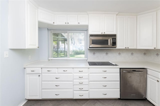 kitchen featuring white cabinets, decorative backsplash, and appliances with stainless steel finishes