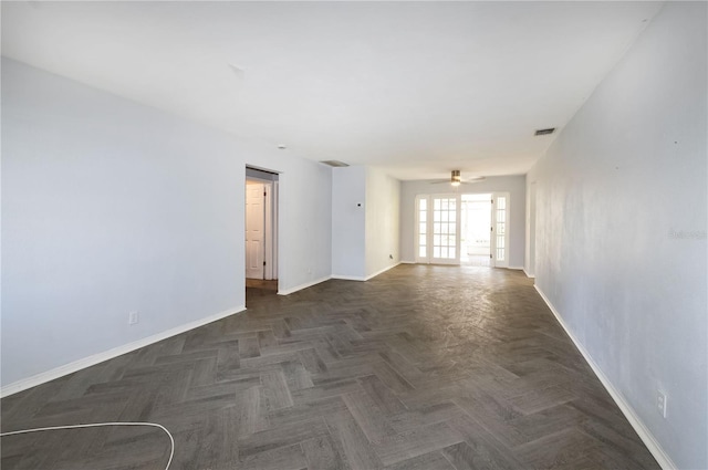 empty room with ceiling fan and dark parquet floors