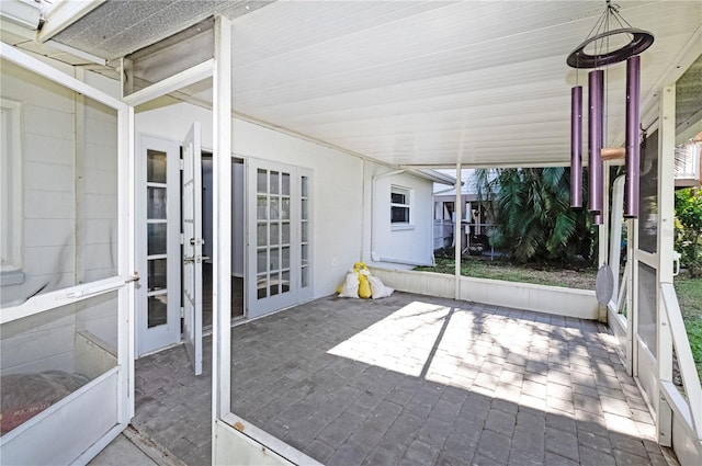 unfurnished sunroom with french doors