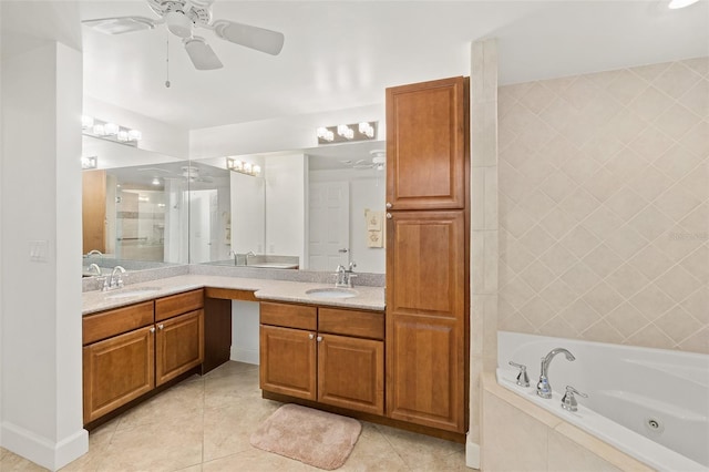 bathroom with tile patterned floors, tiled bath, and vanity