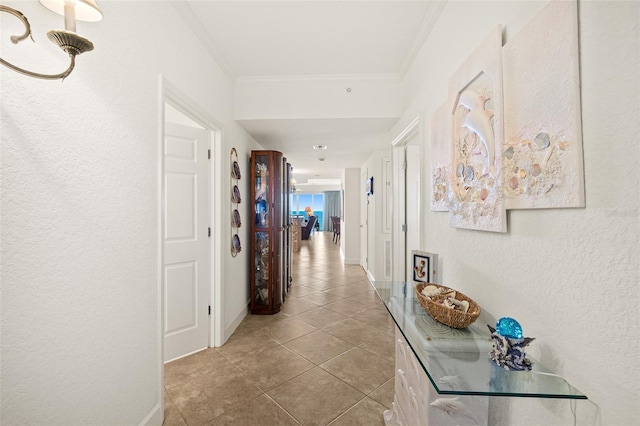 hallway with tile patterned flooring and ornamental molding