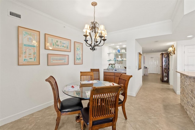 tiled dining area featuring crown molding and an inviting chandelier