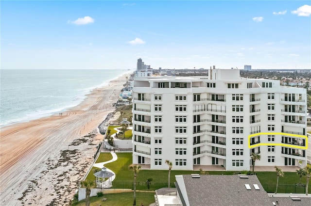 view of property with a beach view and a water view