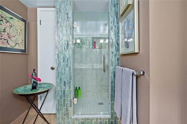 bathroom with a shower with door