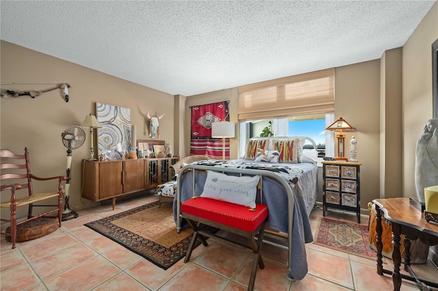 bedroom featuring light tile patterned flooring and a textured ceiling