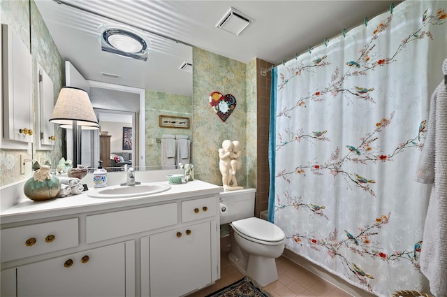 bathroom featuring tile patterned flooring, vanity, a shower with shower curtain, and toilet